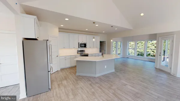 a kitchen with stainless steel appliances a refrigerator sink and cabinets
