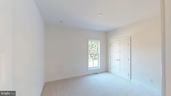 an empty room with windows and closet