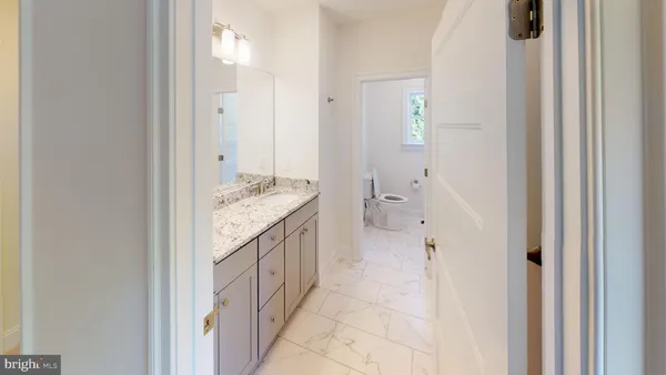 a spacious bathroom with a granite countertop sink