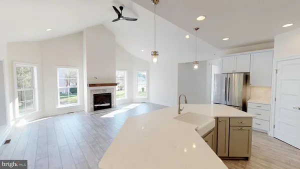 a large kitchen with sink a refrigerator and a stove top oven