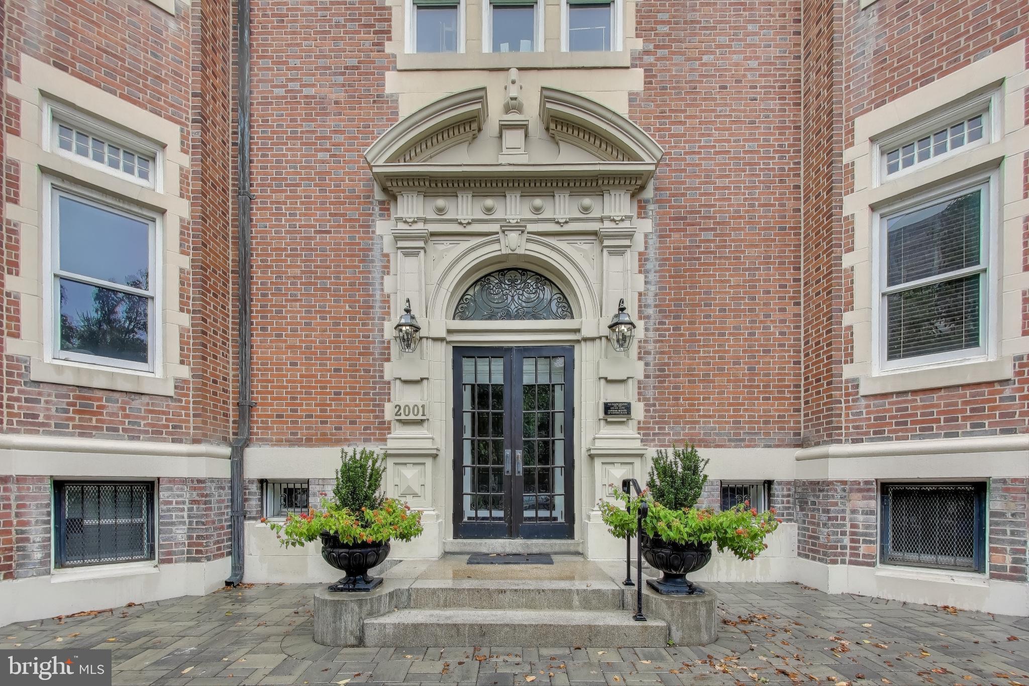 a front view of a house with potted plant