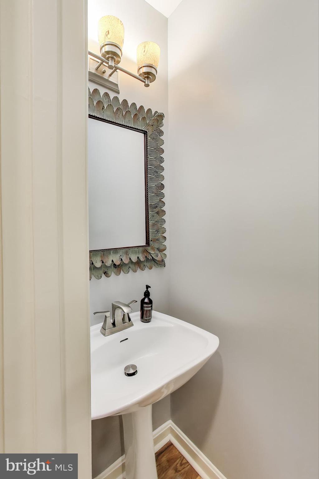 2001 19th Street Northwest, Unit 3 Washington, DC 20009 - Photo 11 of 29 a bathroom with a sink a mirror and vanity