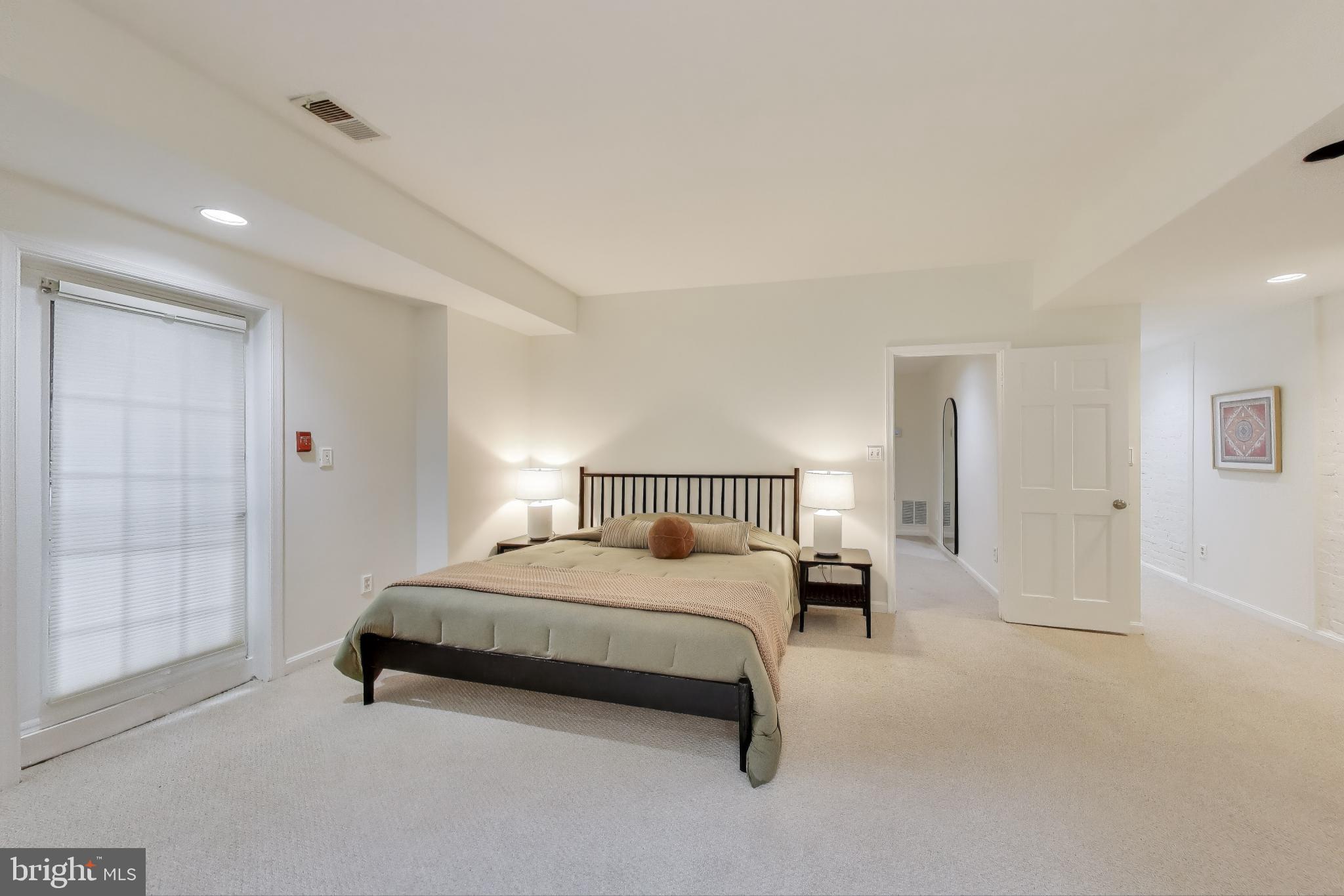 2001 19th Street Northwest, Unit 3 Washington, DC 20009 - Photo 14 of 29 a bedroom with a bed and window