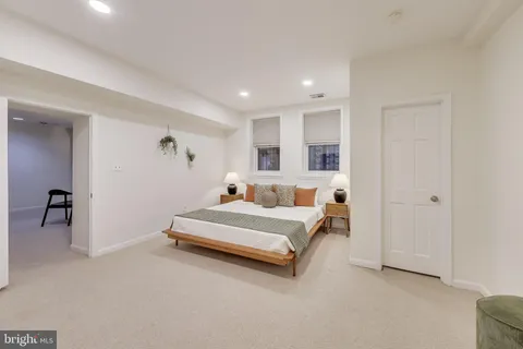 a spacious bedroom with a bed and a couch