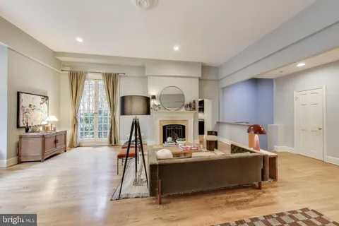 a living room with furniture a fireplace and a table