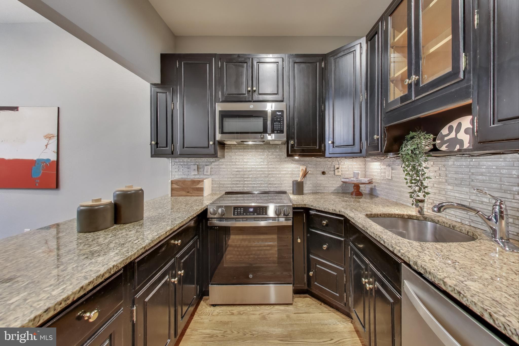 2001 19th Street Northwest, Unit 3 Washington, DC 20009 - Photo 9 of 29 a kitchen with granite countertop stainless steel appliances and sink