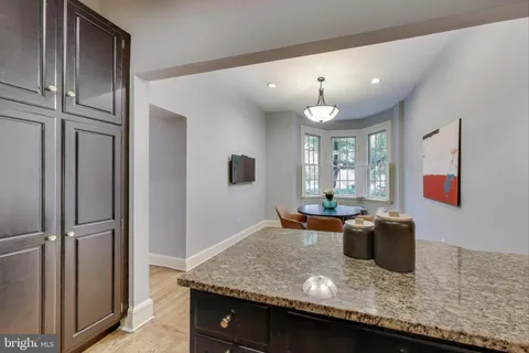 a view of kitchen island with stainless steel appliances granite countertop living room