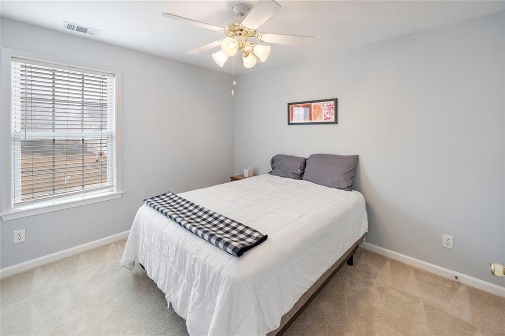 3905 Embassy Way Lilburn, GA 30047 - Photo 17 of 29 a bedroom with a bed and a window