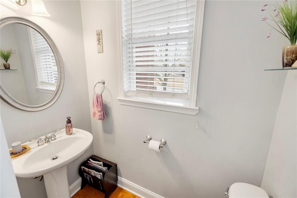 3905 Embassy Way Lilburn, GA 30047 - Photo 22 of 29 a bathroom with a sink mirror and toilet