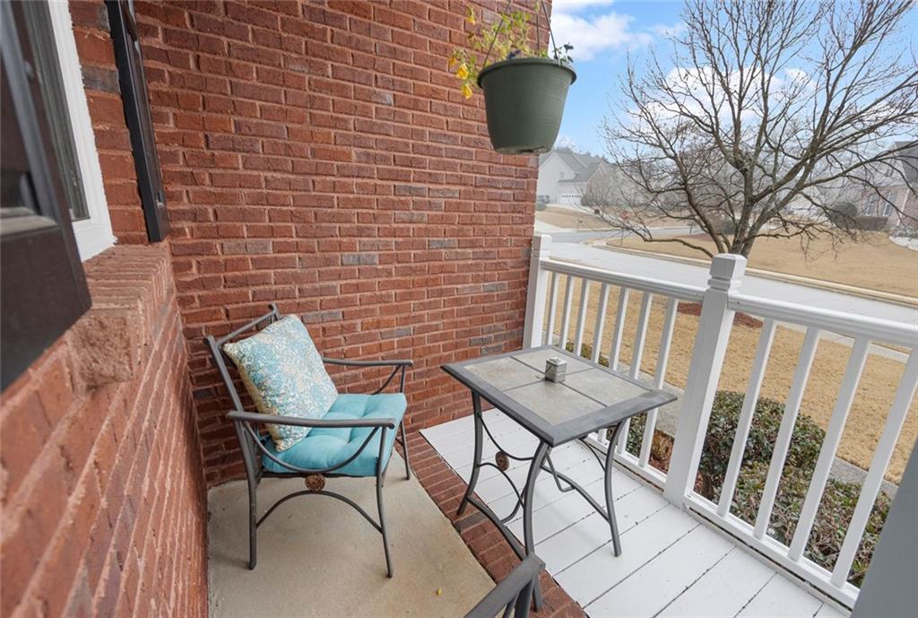 3905 Embassy Way Lilburn, GA 30047 - Photo 25 of 29 a balcony with table and chairs