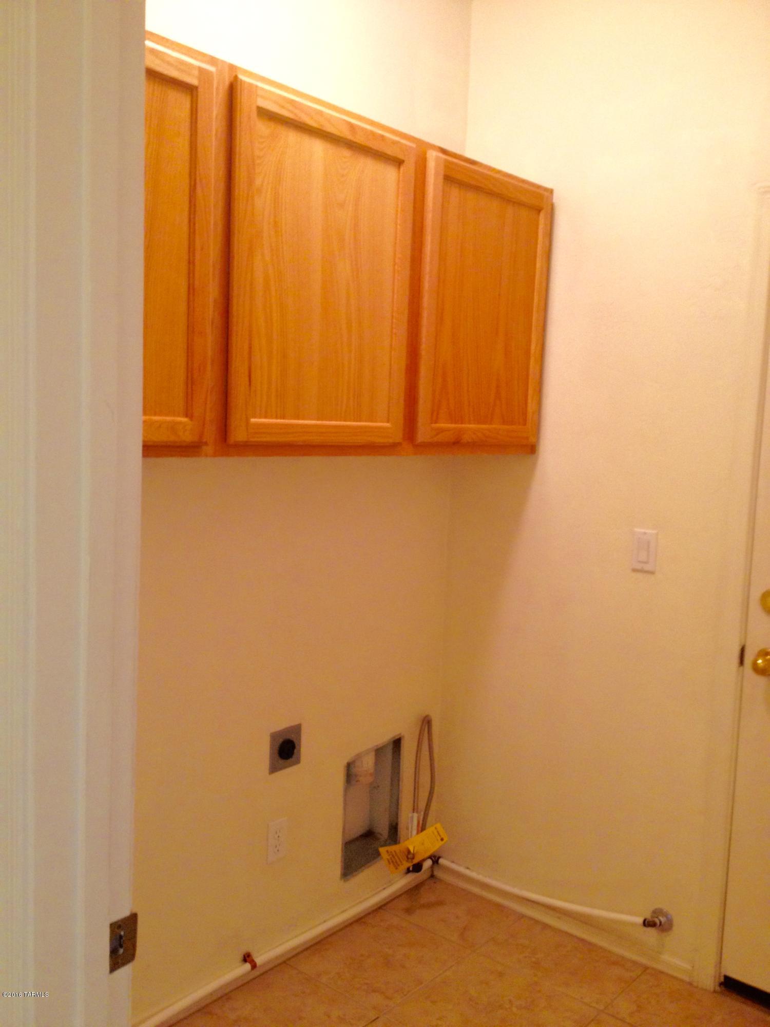 7931 North Iron Ridge Drive Tucson, AZ 85743 - Photo 8 of 21 a view of a room with dryer and washer