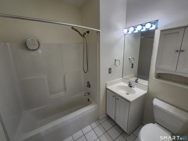 a bathroom with a sink toilet tub and shower