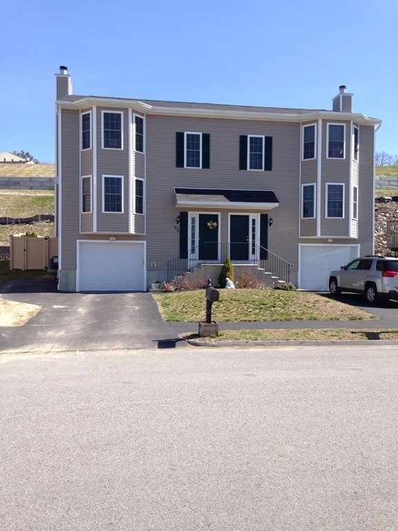 52 Honeysuckle Road Worcester, MA 01607 - Photo 1 of 15 a front view of a house with a yard