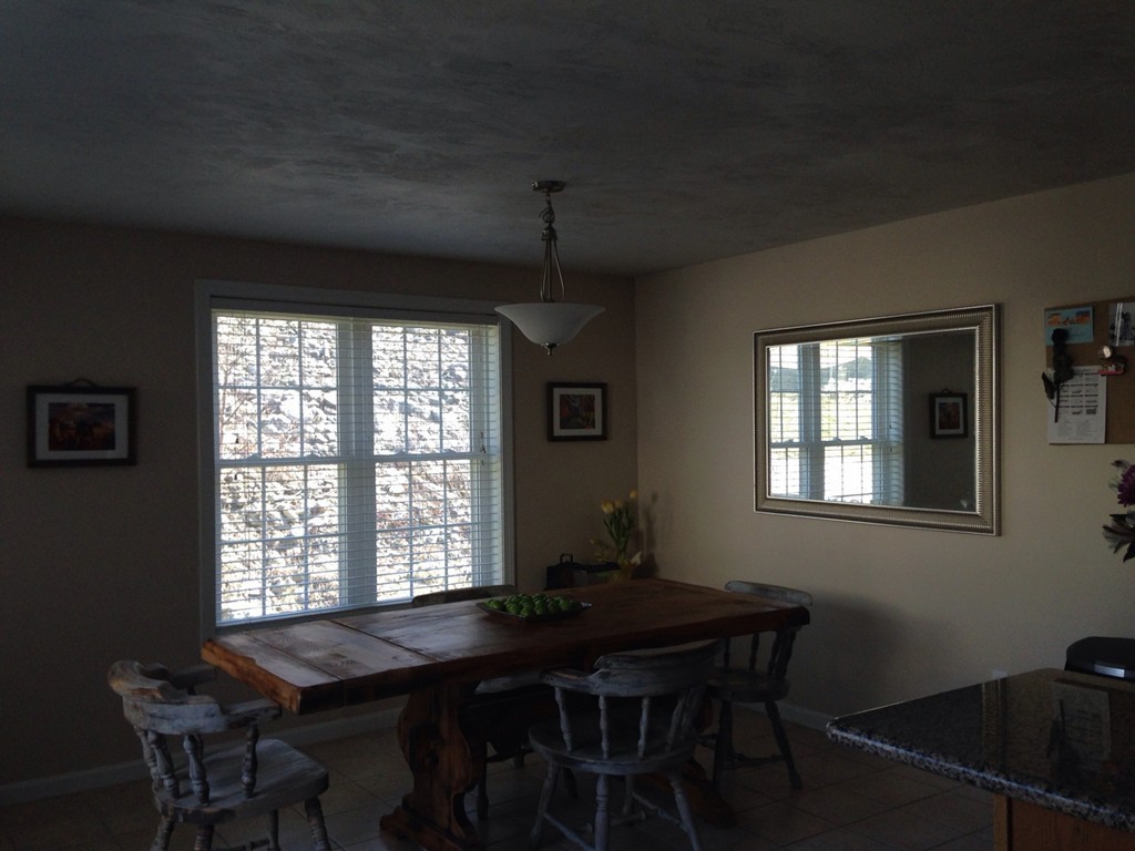 52 Honeysuckle Road Worcester, MA 01607 - Photo 3 of 15 a room that has a table and chairs in it