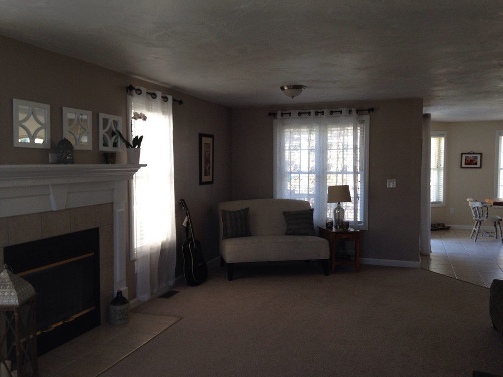 52 Honeysuckle Road Worcester, MA 01607 - Photo 4 of 15 a living room with furniture and a fireplace