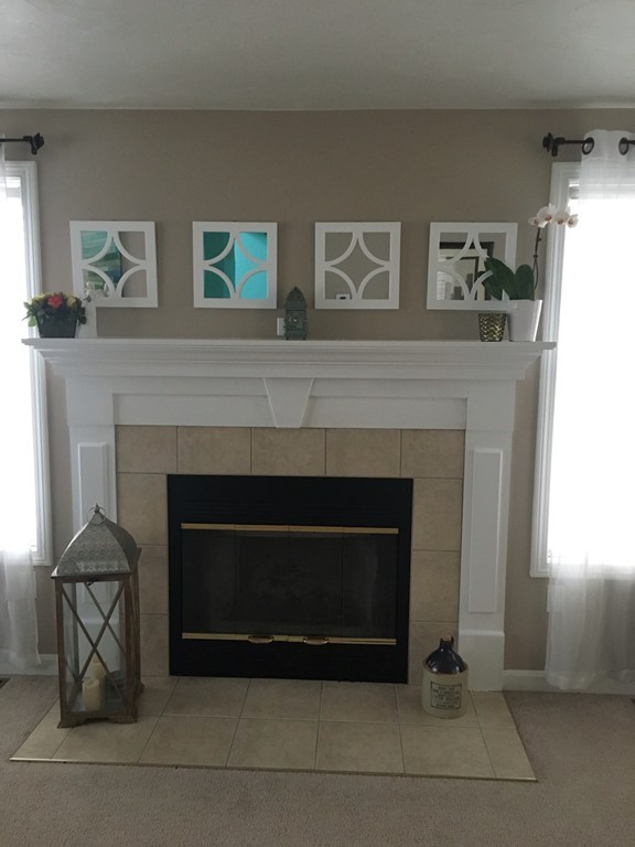 52 Honeysuckle Road Worcester, MA 01607 - Photo 6 of 15 a living room with a fireplace and a table