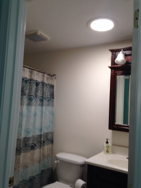 52 Honeysuckle Road Worcester, MA 01607 - Photo 7 of 15 a bathroom with a sink mirror toilet and shower