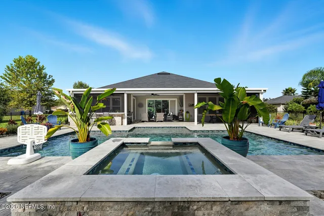 a view of a house with swimming pool and sitting area