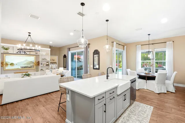 a view of a kitchen with a sink and a refrigerator
