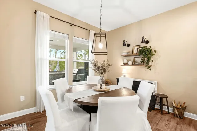 a living room with large windows and furniture