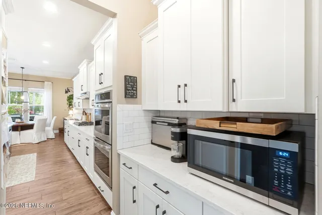 a living room with furniture a flat screen tv and a large window