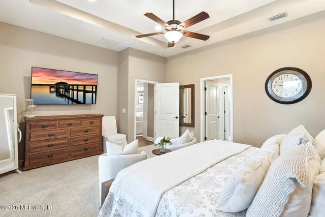 a view of a yard with plants and large trees