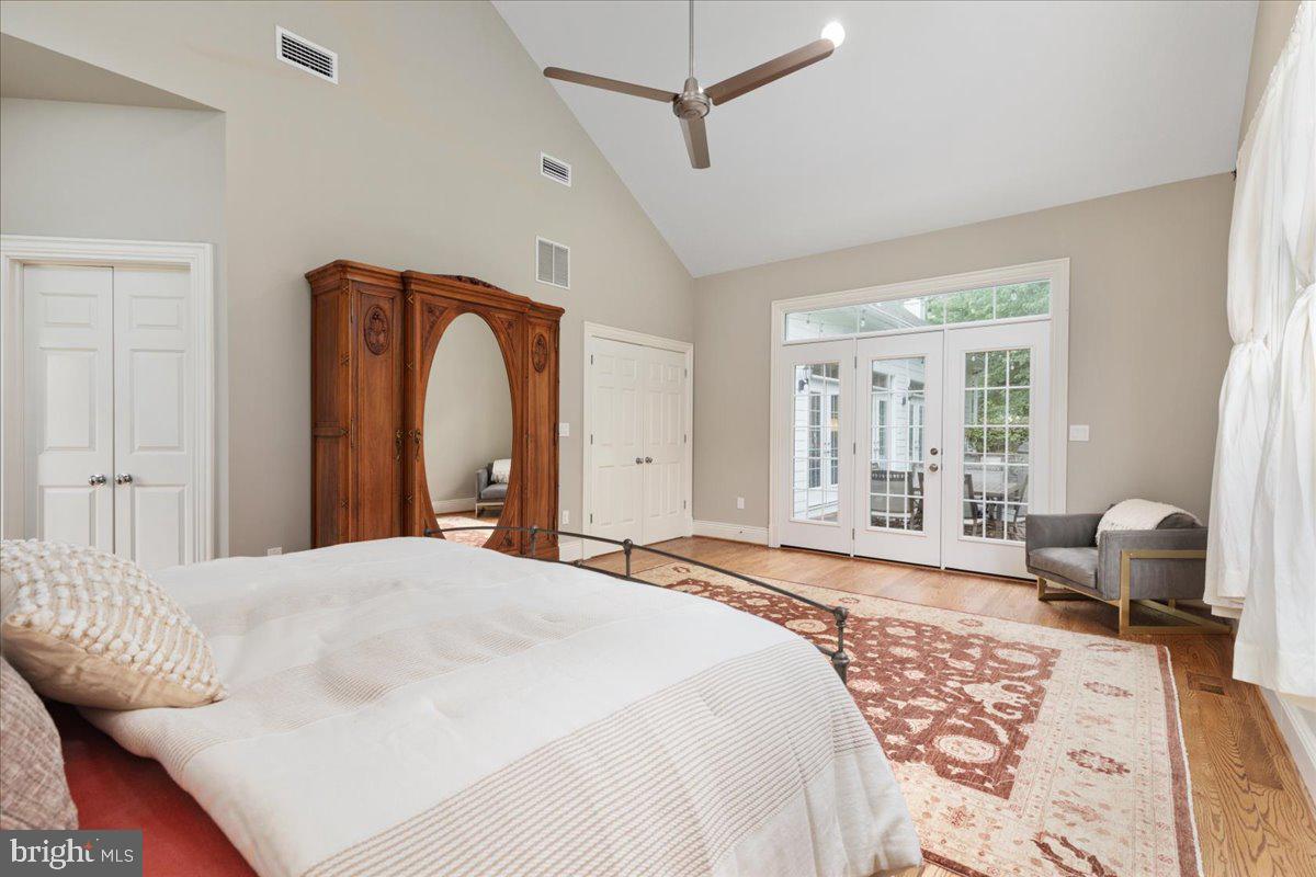 14915 Alpine Bay Loop Gainesville, VA 20155 - Photo 25 of 105 a bedroom with a large bed and wooden floor