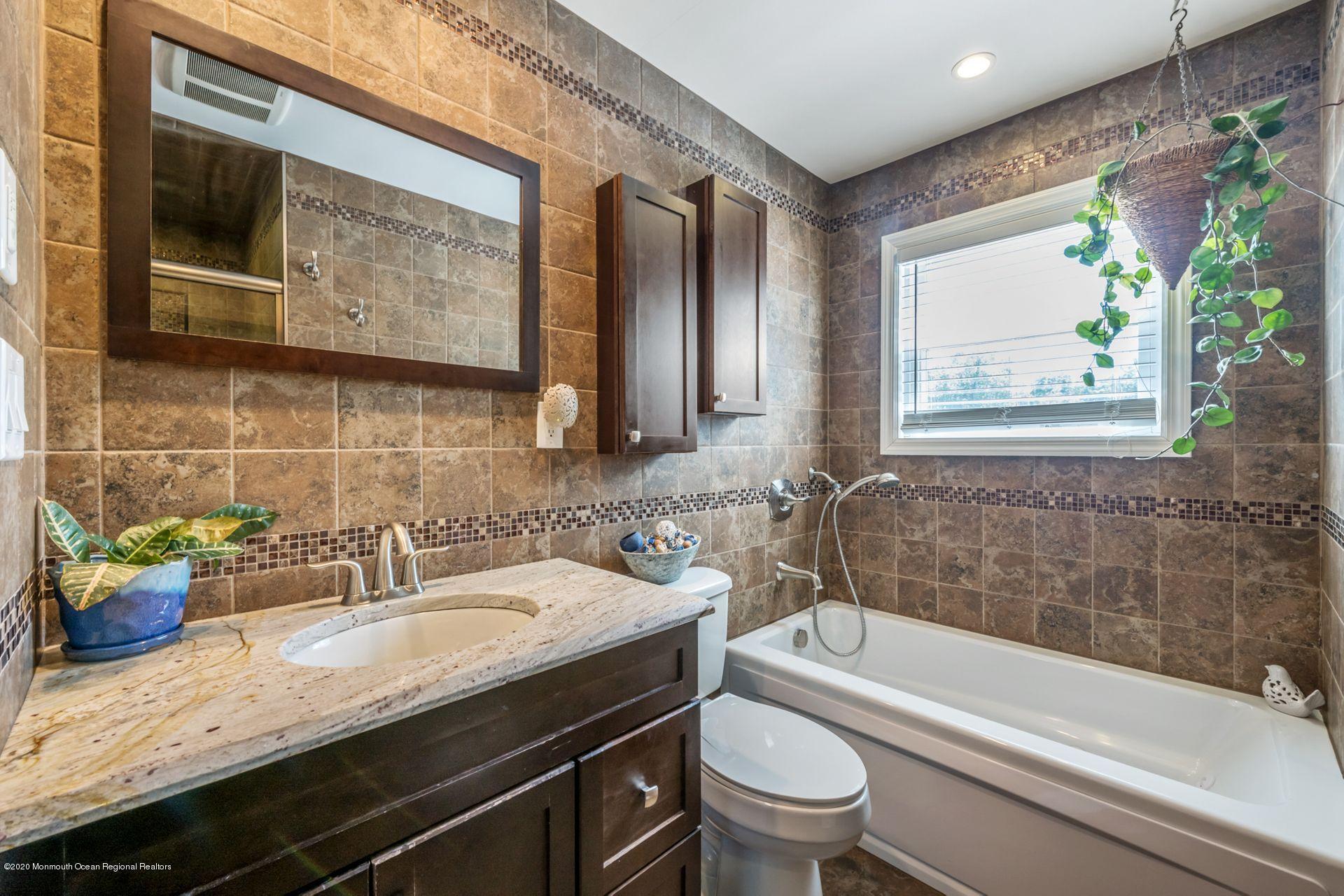 17 Appleman Road Somerset, NJ 08873 - Photo 14 of 20 a bathroom with a granite countertop sink a toilet a bathtub and shower