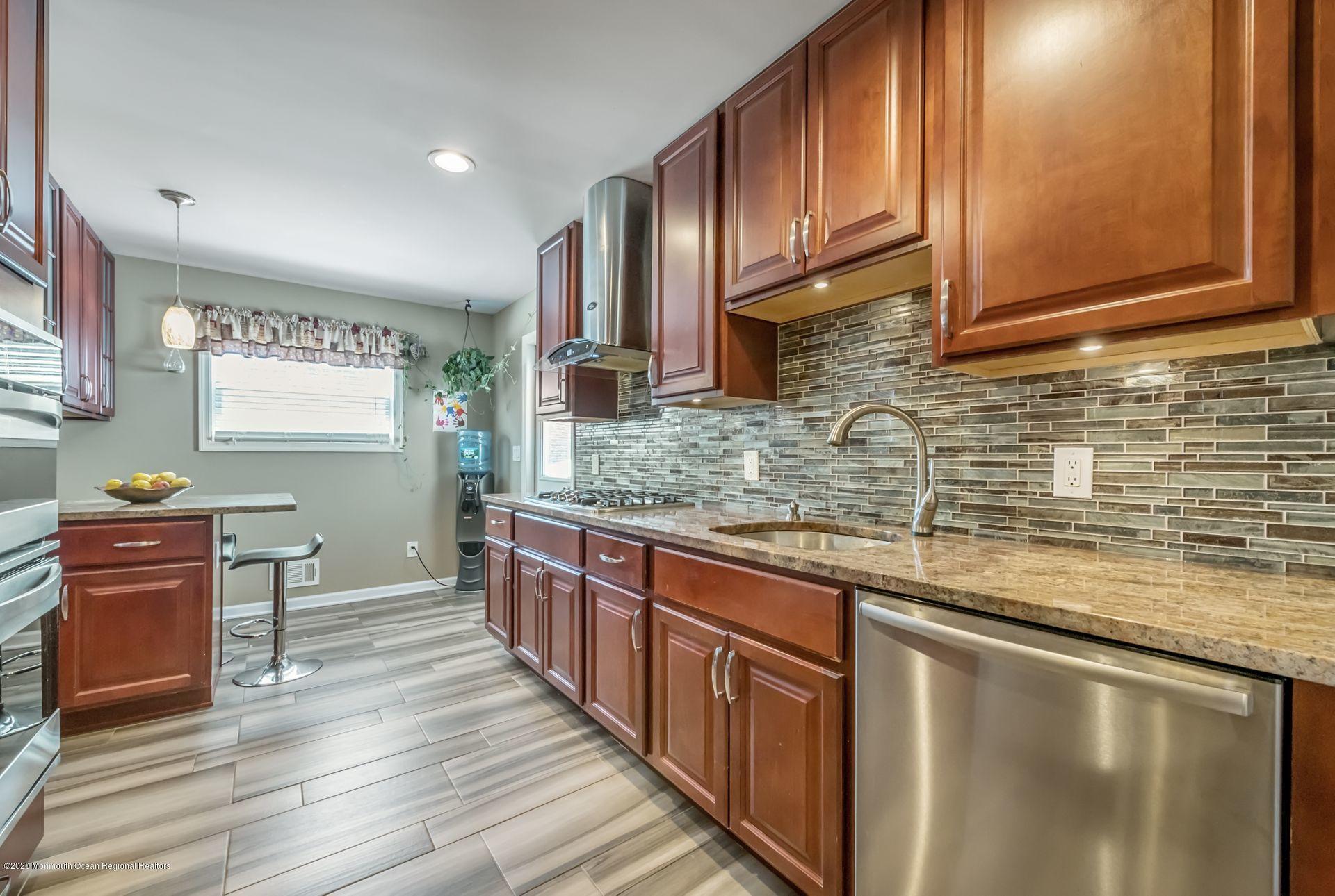 17 Appleman Road Somerset, NJ 08873 - Photo 5 of 20 a kitchen with stainless steel appliances granite countertop wooden cabinets a sink and dishwasher a stove with wooden floor