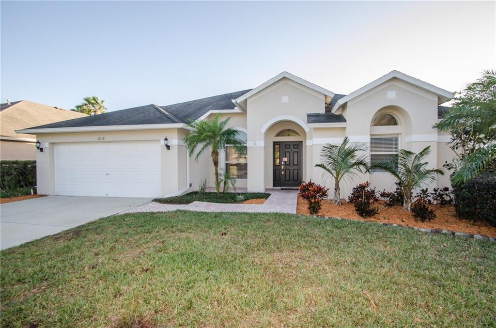 16118 Rambling Road Odessa, FL 33556 - Photo 1 of 1 a front view of a house with a yard and garage