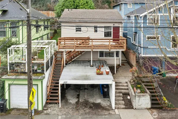 a view of a patio with table and chairs with wooden floor and fence