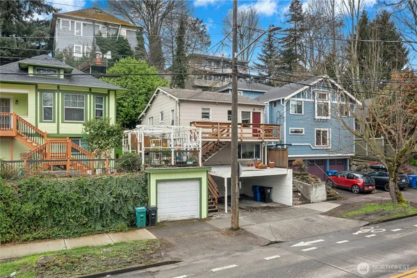 a front view of a house with a yard and a garage