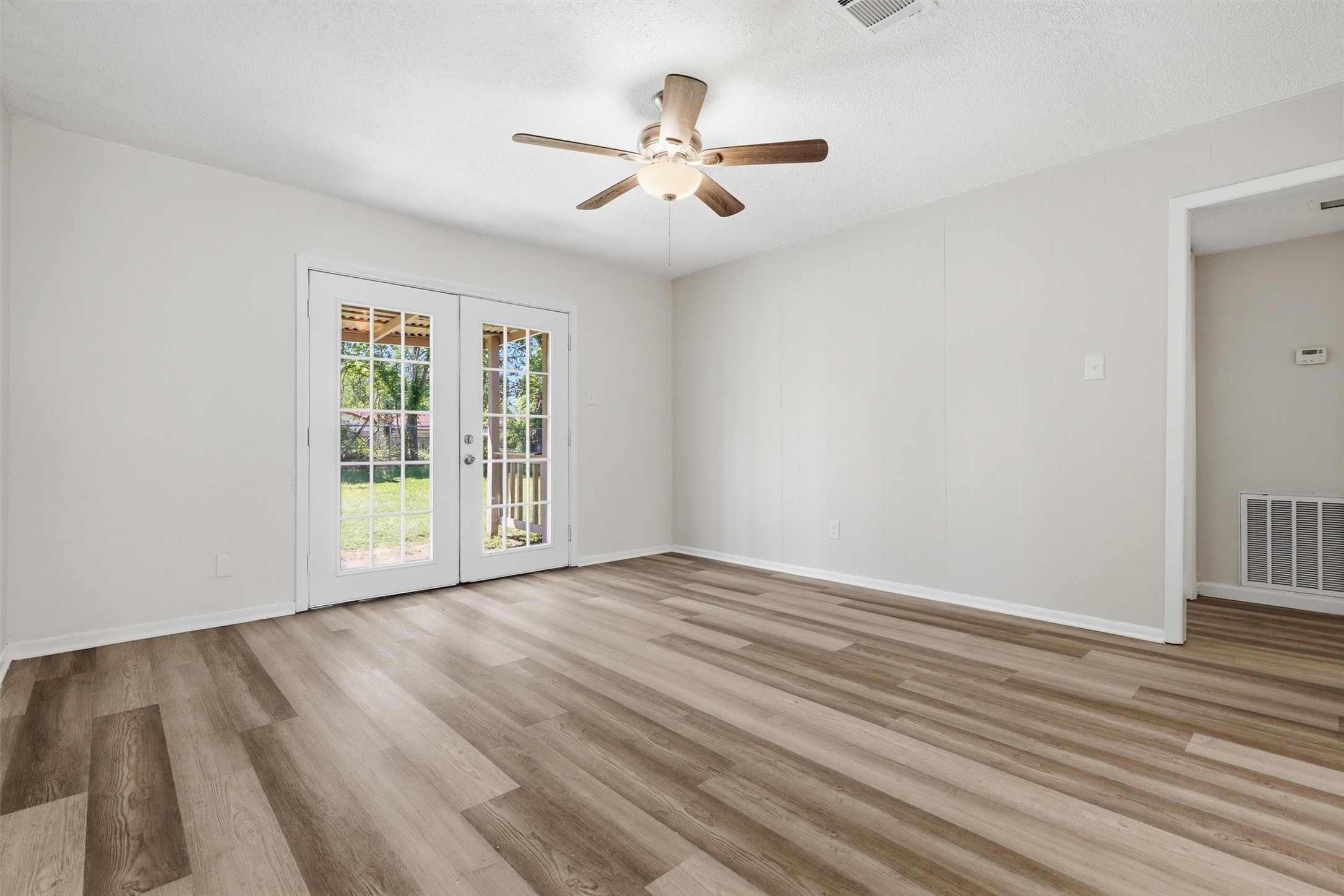 1503 Tarberry Road Houston, TX 77088 - Photo 4 of 33 The living room is fresh and inviting with French doors to access the covered, back patio.