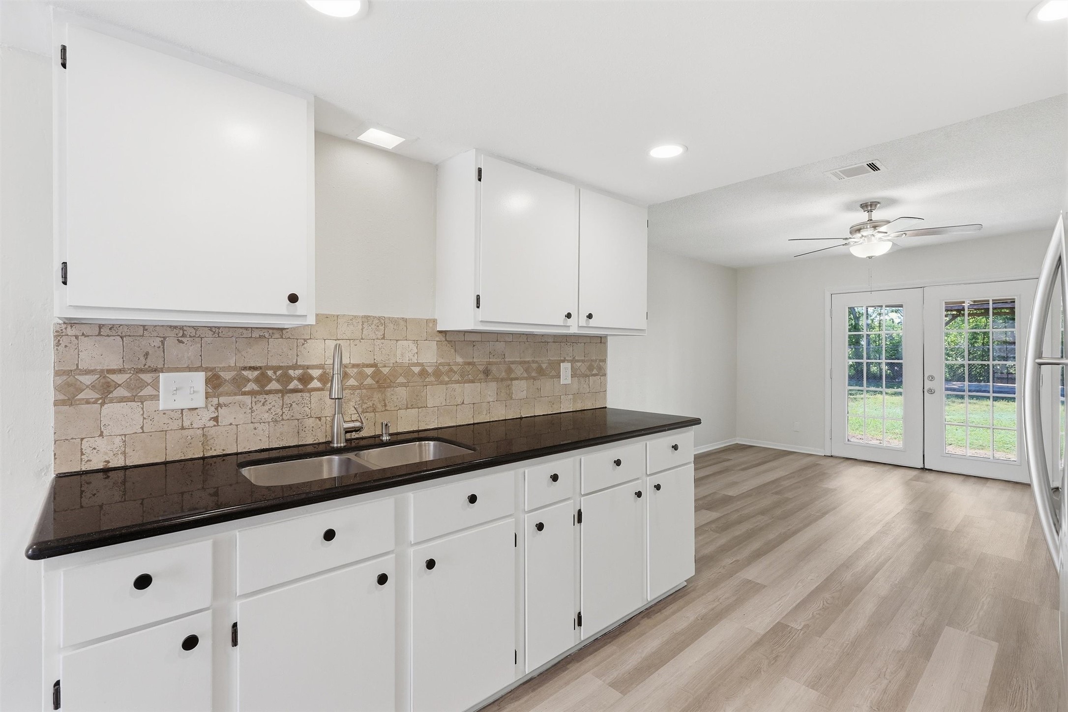 1503 Tarberry Road Houston, TX 77088 - Photo 7 of 33 The kitchen has been freshly updated with crisp white cabinets and accenting black hardware.