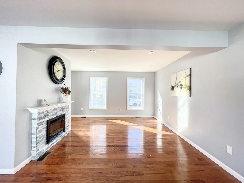 53 Cloran Street Springfield, MA 01109 - Photo 12 of 26 a view of an empty room with wooden floor and fireplace