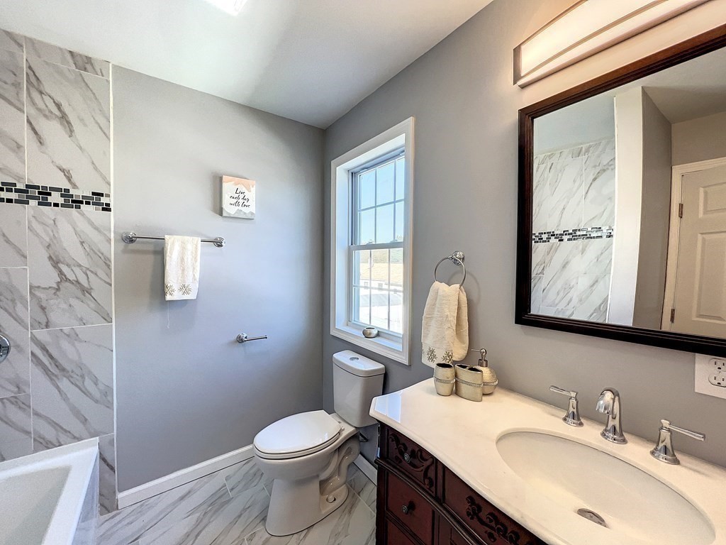 53 Cloran Street Springfield, MA 01109 - Photo 17 of 26 a bathroom with a toilet sink and mirror