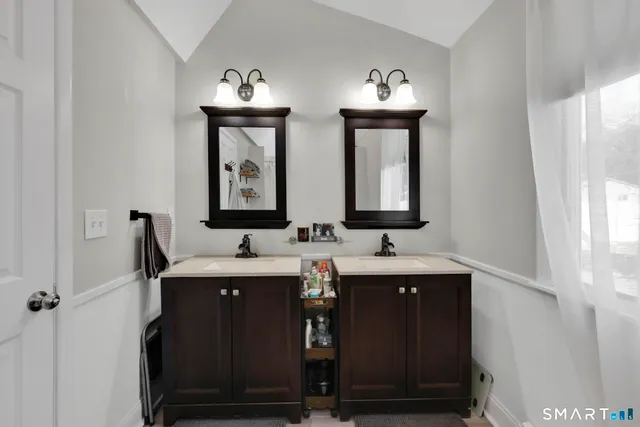 a bathroom with 2 sink and a mirror