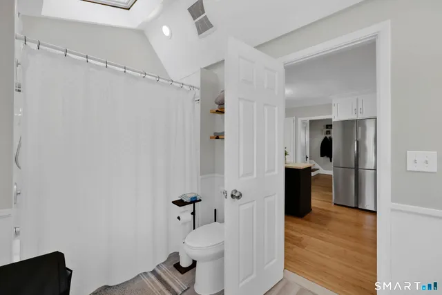 a view of a bathroom with a tub and shower
