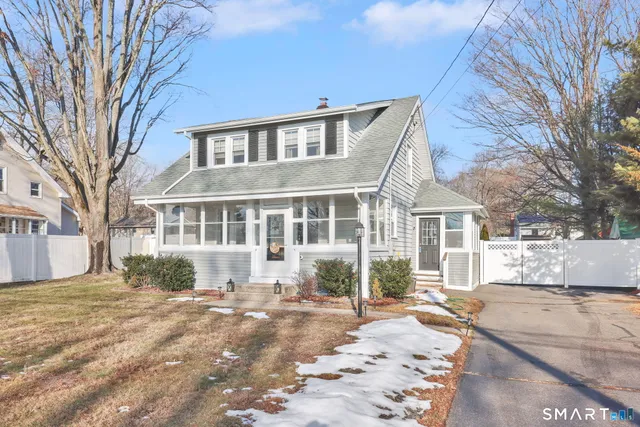 a view of a house with a yard covered in snow