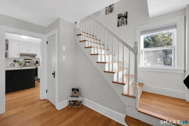 a view of entryway with wooden floor and stairs