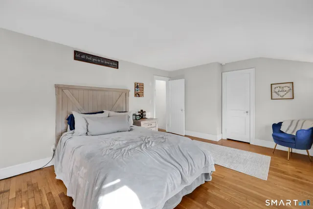 a bedroom with a bed and a couch