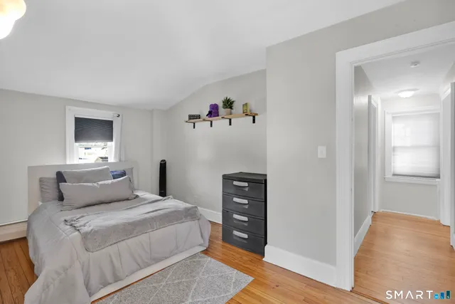 a bedroom with a bed and a couch