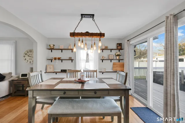 a dining room with furniture and wooden floor