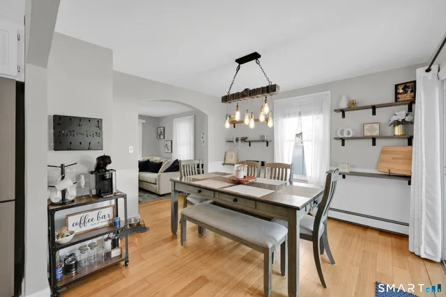 a view of a dining room with furniture and wooden floor