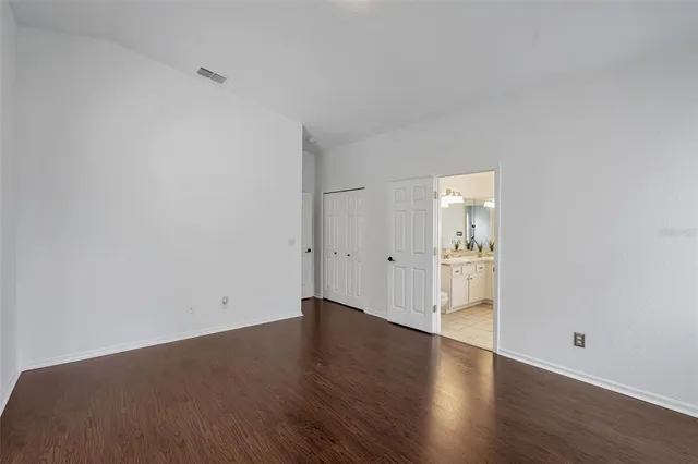 a view of a room with wooden floor and windows