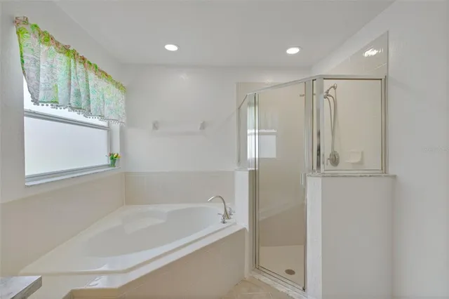 a bathroom with a bathtub and a shower