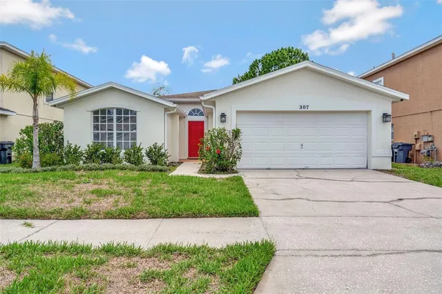 a front view of house with garage and yard