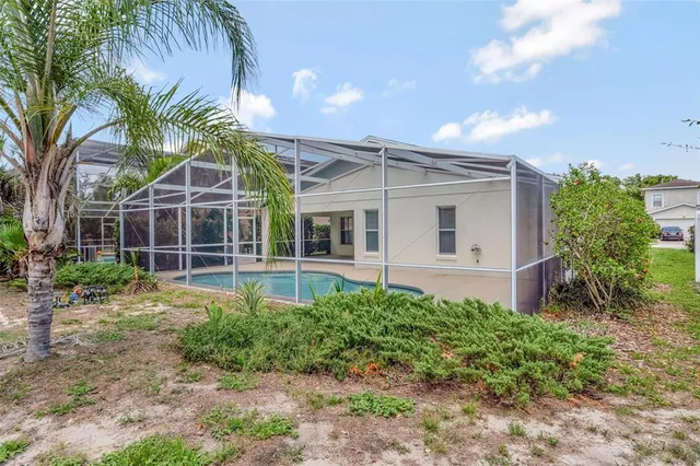 a view of a house with a yard and potted plants
