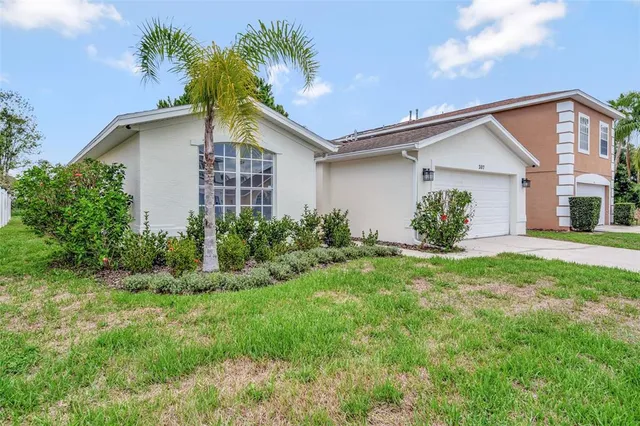 a view of a house with a yard and plants