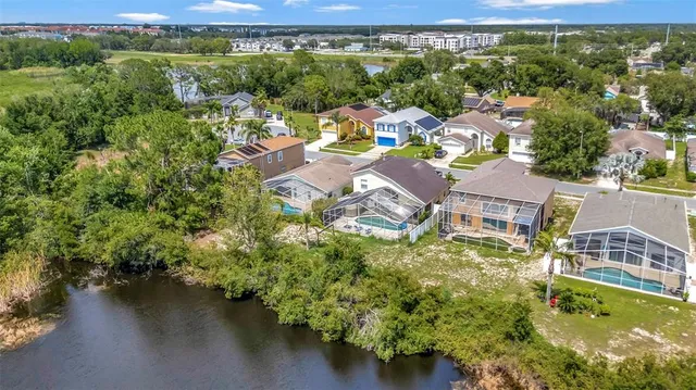 an aerial view of residential house with outdoor space and lake view